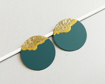 May include: Two round teal green earrings with a gold accent on the top half of each earring.