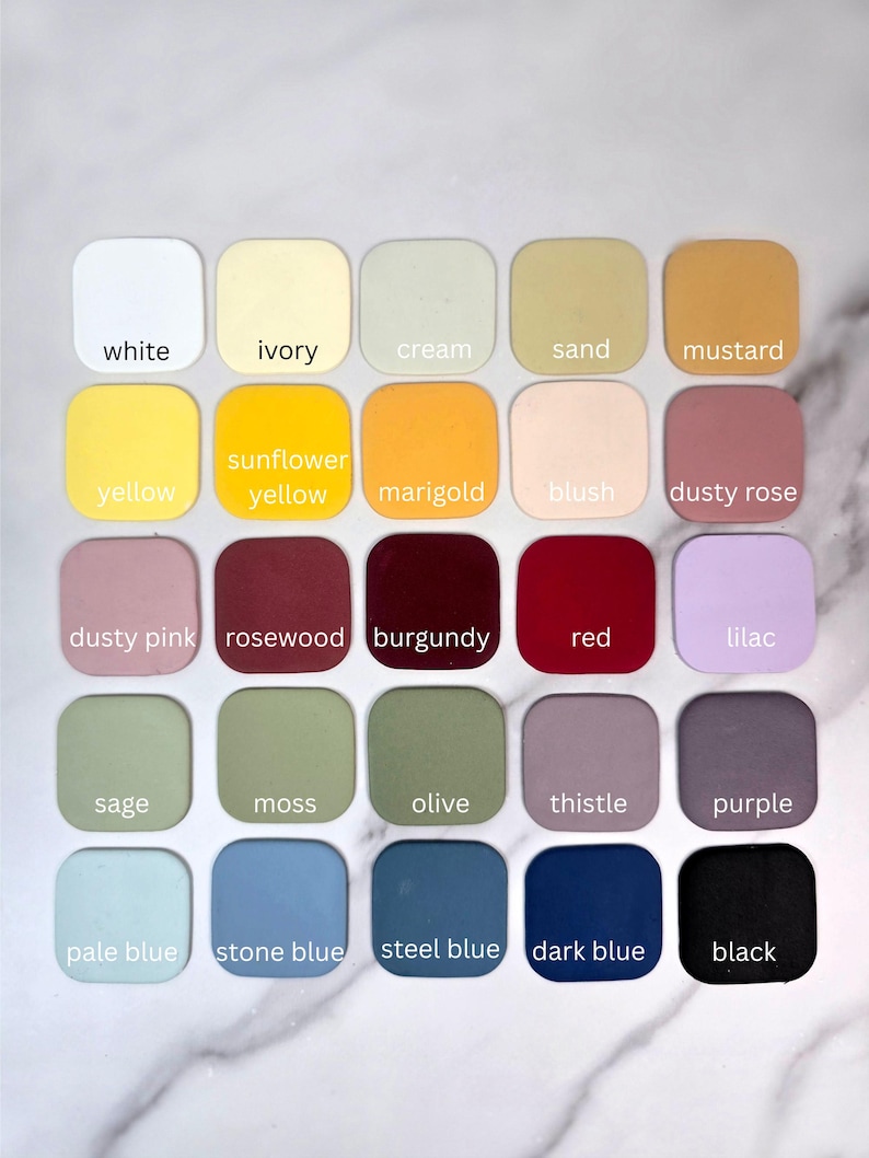 May include: A grid of twenty-five square colour swatches with rounded corners, each labelled with its corresponding colour name: white, ivory, cream, sand, mustard, yellow, sunflower yellow, marigold, blush, dusty rose, dusty pink, rosewood, burgundy, red, lilac, sage, moss, olive, thistle, purple, pale blue, stone blue, steel blue, dark blue, and black.