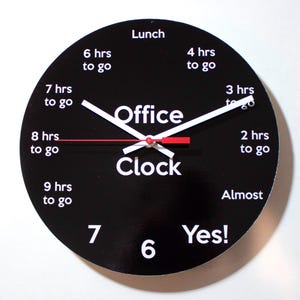 May include: A black office clock with white numbers and hands. The clock face has the words "Office Clock" and shows the hours remaining until lunch, with phrases like "6 hrs to go" and "Almost".