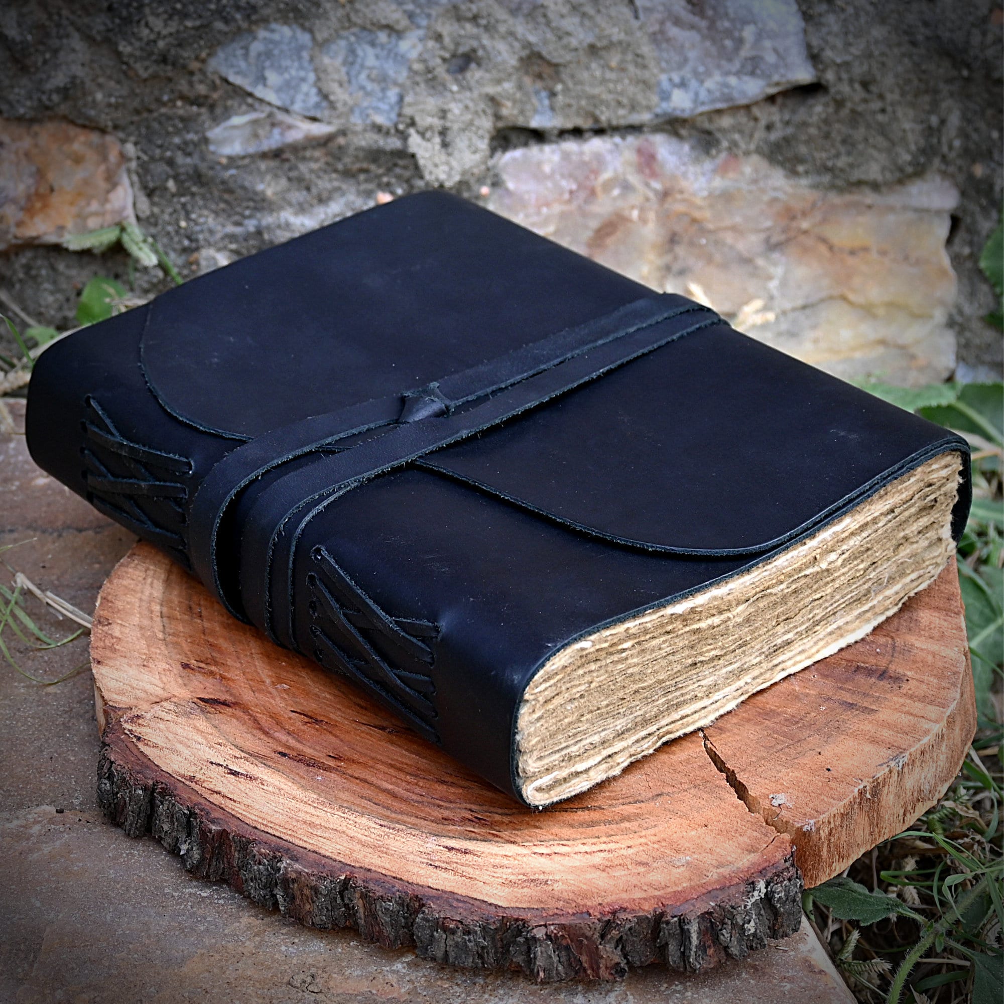 An Open Leather Bound Black Journal Outdoors On Table, Revealing