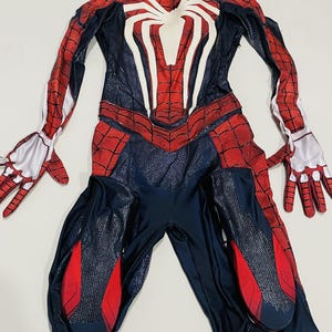 May include: A full-body Spider-Man costume in red, white, and navy blue. The costume features a large white spider emblem on the chest and red web patterns. Includes gloves and a mask.