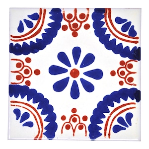Op de afbeelding: Vierkante witte keramische tegel met een symmetrisch bloemmotief. Het ontwerp toont een centrale blauwe bloem met een rood hart, omringd door blauwe en rode decoratieve elementen. Voor interieurdecoratie.
