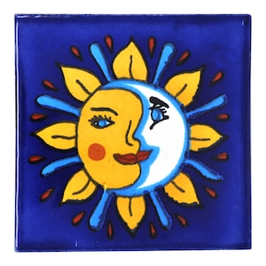 May include: Square ceramic tile with a sun and moon face design. The sun is yellow with a red cheek and the moon is white. The design is surrounded by yellow leaves and blue accents, set against a deep blue background.