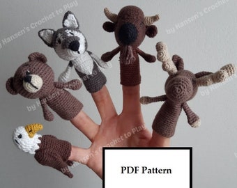 May include: A set of five finger puppets featuring a bear, wolf, bison, moose, and eagle. The puppets are crocheted in brown, white, and gray yarn. The puppets are on a hand, with the text "PDF Pattern" visible in the lower right corner.