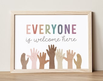 May include: A framed print with the text "EVERYONE is welcome here" in rainbow colors. The print features a row of raised hands of different skin tones.