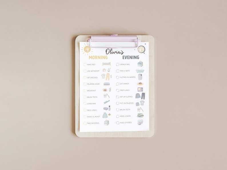 May include: A light-colored clipboard with a checklist for morning and evening routines. The checklist includes tasks like "Make Bed" and "Brush Teeth." The name "Olivia's" is written at the top. The clipboard has a light purple clip.