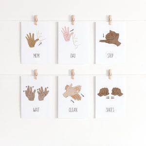 May include: Six white cards with illustrations of American Sign Language signs. The signs are for the words "Mom", "Dad", "Stop", "Wait", "Clean", and "Shoes".