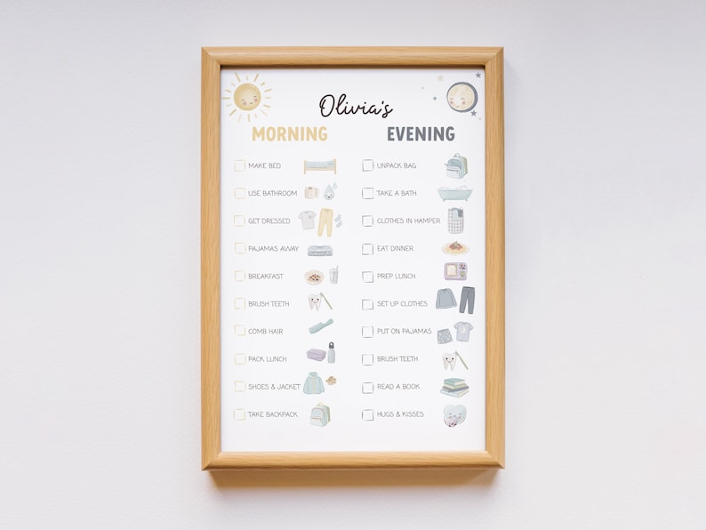 May include: A framed daily routine chart with the name "Olivia's" at the top. The chart is divided into "Morning" and "Evening" sections, each with illustrated tasks like "Make Bed," "Brush Teeth," and "Read a Book." The frame is made of light brown wood.