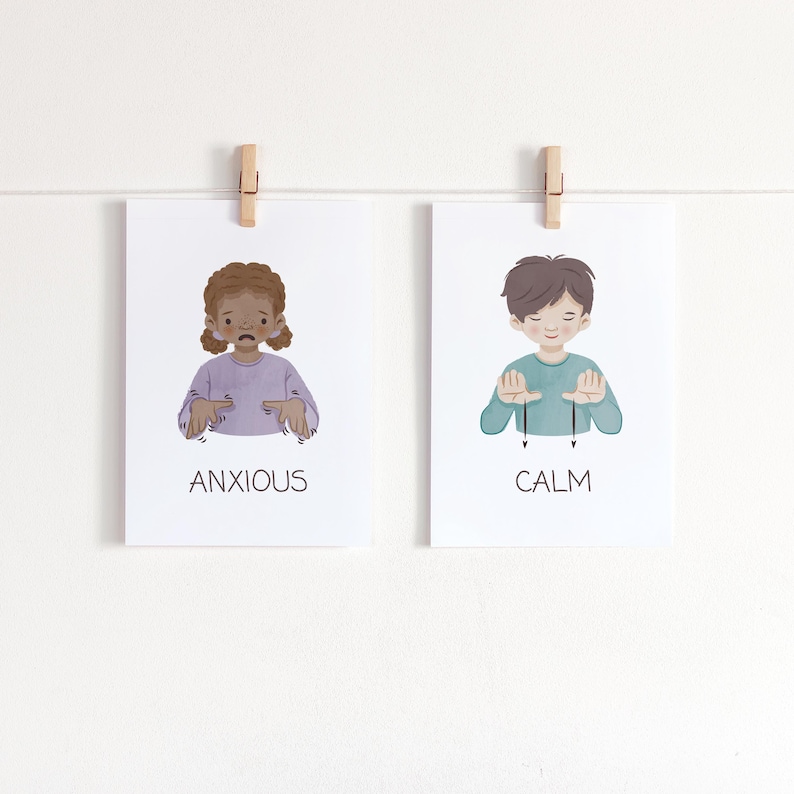 May include: Two art prints, each held by a wooden clip. One print shows a child with the word "ANXIOUS" below. The other print shows a child with the word "CALM" below. Both prints have a white background.