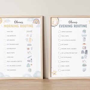 May include: Two framed prints with a light wood finish. The left print says "Olivia's Morning Routine" and the right print says "Olivia's Evening Routine". Each print has a checklist with illustrations of daily activities, such as brushing teeth and eating breakfast.