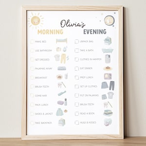 May include: A framed daily routine chart for "Olivia's" morning and evening activities. The chart includes illustrations and text for tasks like "Make Bed," "Brush Teeth," and "Read a Book." The design features a sun and moon.