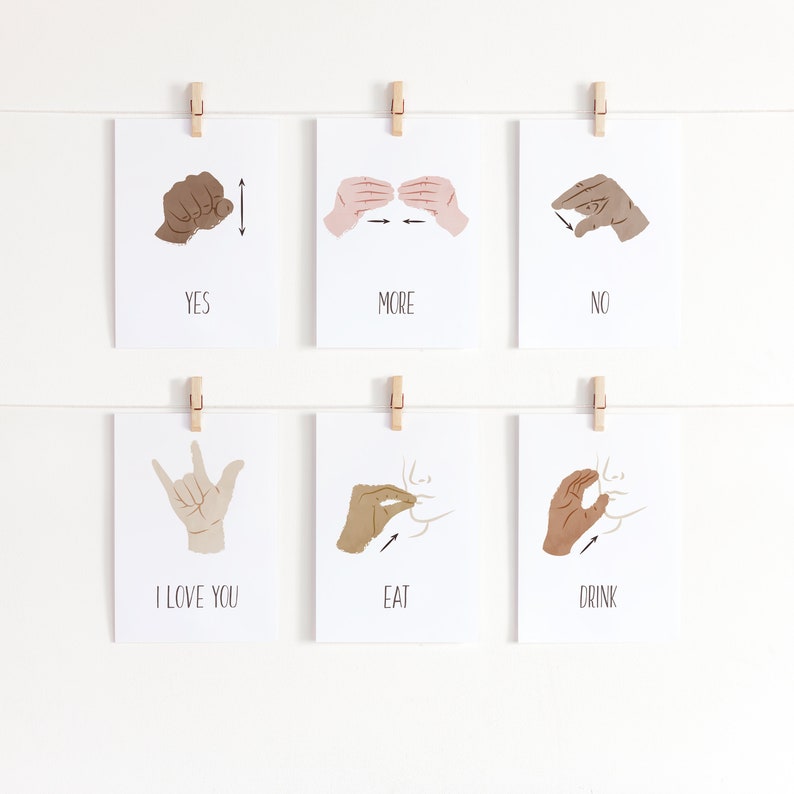 May include: Six white cards with black text and illustrations of hands signing different words in American Sign Language. The words are "YES", "MORE", "NO", "I LOVE YOU", "EAT", and "DRINK".