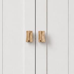 May include: A pair of natural wood cabinet pulls on a white cabinet door. The pulls have a rectangular shape and a textured, organic design. The cabinet door is white.