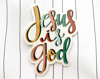 May include: A sticker with the words "Jesus is God" written in a colorful, handwritten style. The words are in a variety of colors, including yellow, orange, red, pink, green, and blue.