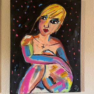 May include: Abstract painting of a seated figure with blonde hair and red lips. The figure is painted with bold brushstrokes in various colors against a black background with colorful dots. A cross pendant hangs around the figure's neck.