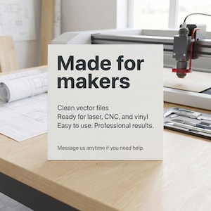 May include: A white sign with the text "Made for makers" in black. The sign also includes the phrases "Clean vector files," "Ready for laser, CNC, and vinyl," and "Easy to use. Professional results." The sign is on a wooden surface.