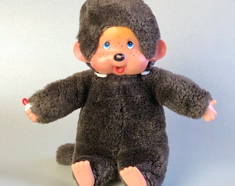 Peluche tétine vintage singe Monchhichi Sekiguchi, fourrure brune, yeux bleus, grandes oreilles, jouet de collection, cadeau souvenir du Japon des années 70.