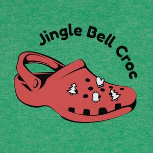 Könnte beinhalten: Ein roter Clog mit weihnachtlichen Charms, darunter eine Glocke, Fäustlinge und Weihnachtsbäume, vor einem grünen Hintergrund. Der Text "Jingle Bell Croc" ist über dem Clog angeordnet.