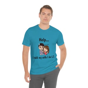 May include: A turquoise blue t-shirt with a cartoon couple on the front. The man is holding a phone with a low battery icon and the woman is saying "Low Batt!" The text on the shirt reads "Help... I told my wife I do I.T."