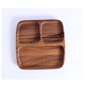 May include: A wooden serving tray with three compartments. The tray is made of dark brown wood and has a rectangular shape.