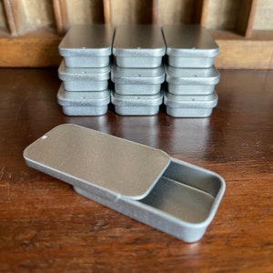 Ten rectangular metal tins with sliding lid. 4 sizes available