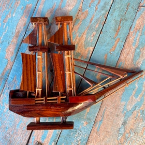 Vintage wooden model boat with moving sails