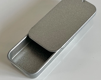 Small rectangular metal tin with sliding lid. 51 x 26 x 9mm