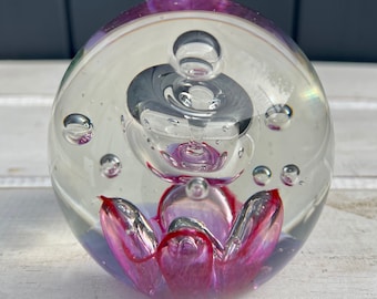 Pretty vintage glass paperweight with pink petals and controlled bubbles