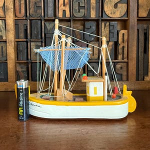 Vintage wooden fishing boat, ship in yellow and white. Nautical decor, Kirkwall souvenir