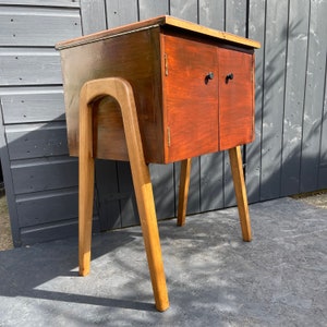 Midcentury wooden sewing box on atomic legs. Walnut veneer, oak legs and a lacquered lid