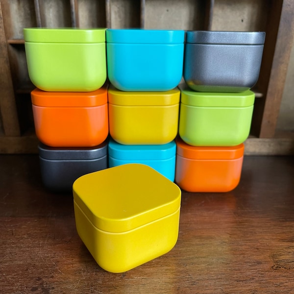 Colourful storage tins for candles, cosmetics, gifts. Yellow, turquoise, green, orange and anthracite