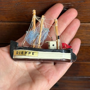 Miniature vintage wooden fishing boat, ship. Nautical decor