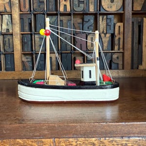 Miniature vintage wooden fishing boat, ship. Nautical decor