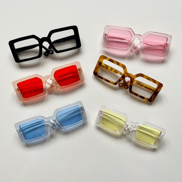 Doll’s reading and sun glasses. Brown, black, pink, yellow, blue and orange