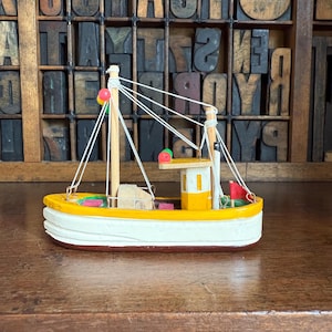 Miniature vintage wooden fishing boat, ship. Nautical decor