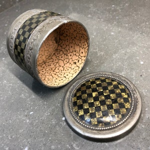Small vintage tin with cork lining