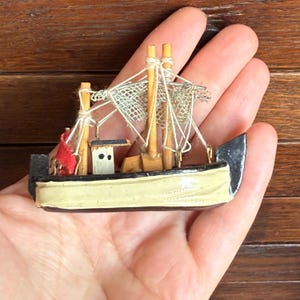 Miniature vintage wooden fishing boat, ship. Nautical decor