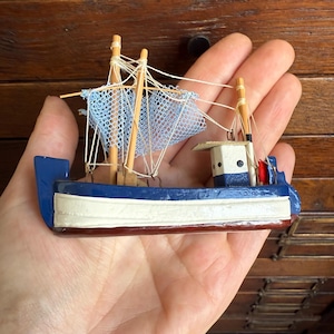 Small vintage blue and white wooden fishing boat, ship. Nautical decor