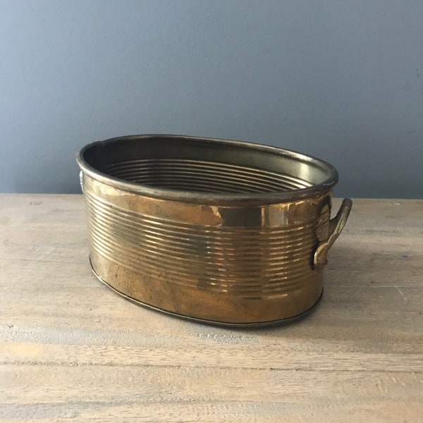 Oval brass planter ribbed with handles