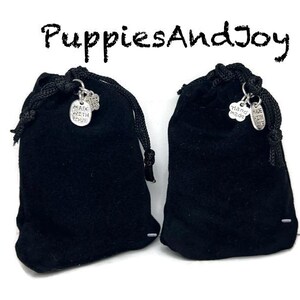 May include: Two black velvet drawstring pouches with silver charms that say "Made with Love" and "Hand Made".
