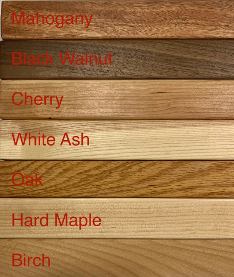 May include: Close-up of seven different wood samples, labeled with their names: Mahogany, Black Walnut, Cherry, White Ash, Oak, Hard Maple, and Birch.