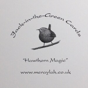 May include: Black and white illustration of a wren perched on a branch. The text "Jack-in-the-Green Cards" is written in a circular arc above the bird. The text "Hawthorn Magic" is below the bird. The text "www.meraylah.co.uk" is below the text "Hawthorn Magic".