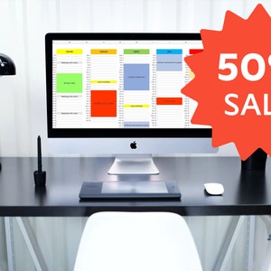 May include: A black desk with a white chair, a computer monitor displaying a spreadsheet, a lamp, a vase with white flowers, a drawing tablet, and a computer mouse. A red starburst with the text "50% SALE" is in the upper right corner of the image.