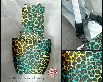 May include: A size XXS Serama chicken diaper featuring a multi-color cheetah print with gradients of yellow, orange, and teal. The garment includes white elastic straps and black plastic buckles for fastening. The text reads Size XXS Serama chicken diaper.