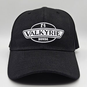 May include: Black baseball cap with a white embroidered logo that says "F6 Valkyrie Honda".
