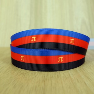 May include: Two rolls of blue, red, and black ribbon with the symbol "π" printed in gold on each roll.