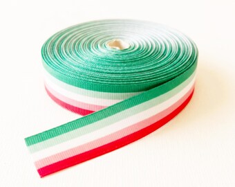 May include: A spool of grosgrain ribbon featuring horizontal stripes in shades of dark green, light green, white, light pink, and red. The ribbon is tightly wound into a circular coil with one end extending outward, showcasing the multi-colored pattern.