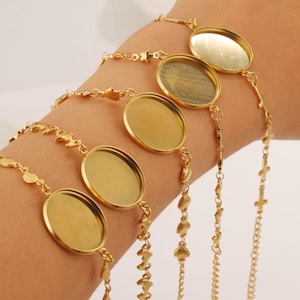 May include: Five gold-toned bracelets with different chain styles and round, blank, metal charms. The charms are all the same size and have a smooth, shiny finish.