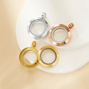 May include: Three round silver locket pendants with glass inserts. The lockets are in silver, gold, and rose gold.