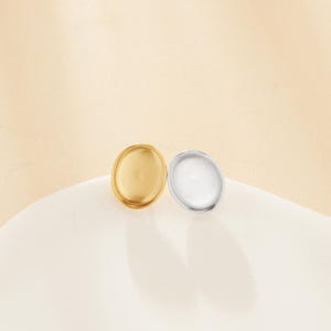 May include: Two round metal earring blanks, one gold and one silver.